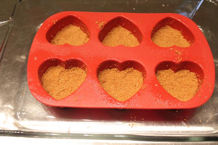 Mix together graham crackers, sugar and melted butter and press them into the bottom of mold
