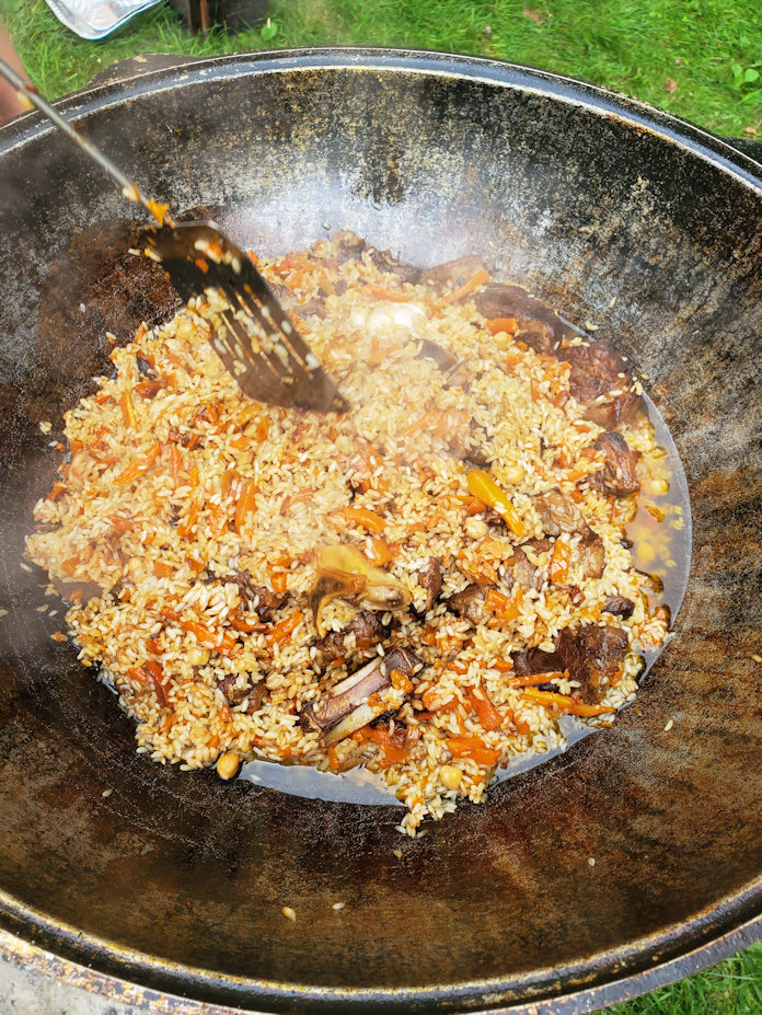 Uzbek Plov cooking in Giant Wok (Kazan) on fire