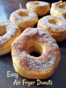 Air fryer donuts dusted with cinnamon sugar