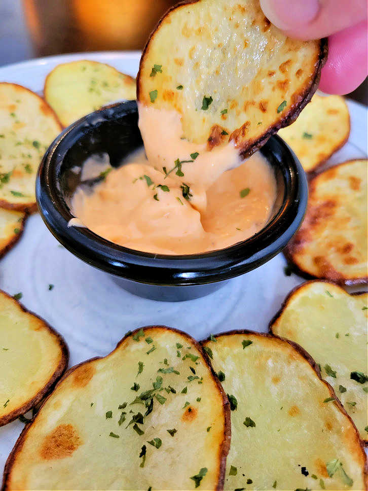 Homemade potato chips with chipotle sauce