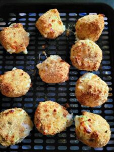 breaded golden jalapeno bites in air fryer basket