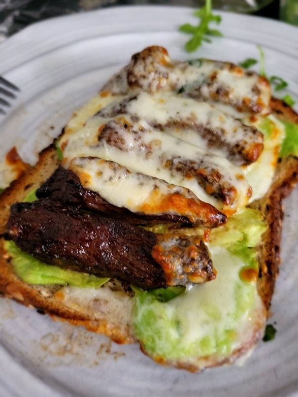 Avocado toast on Dave's killer bread, with skirt steak and melted provolone