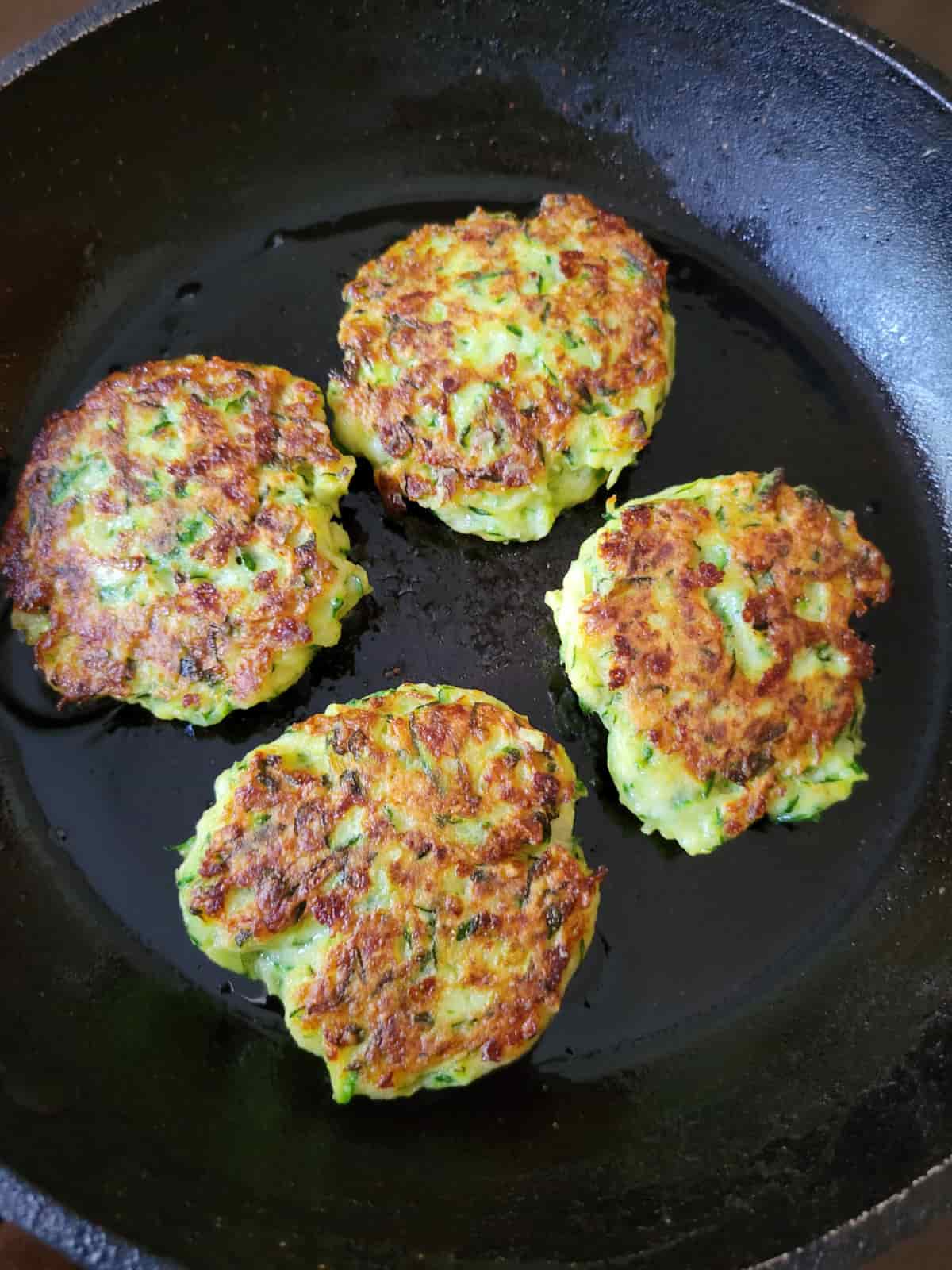 zucchini fritters in a fry pan