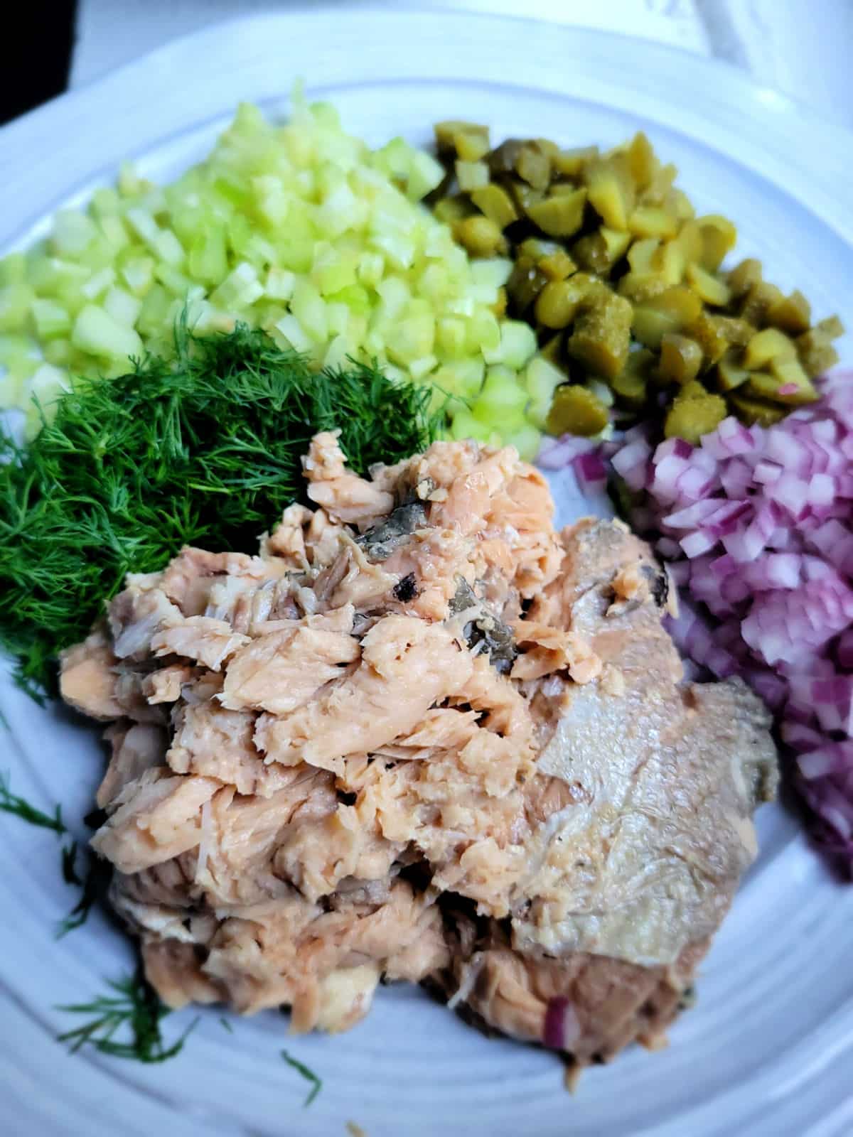 chopped pickles, celery, onion and dill for tuna salad