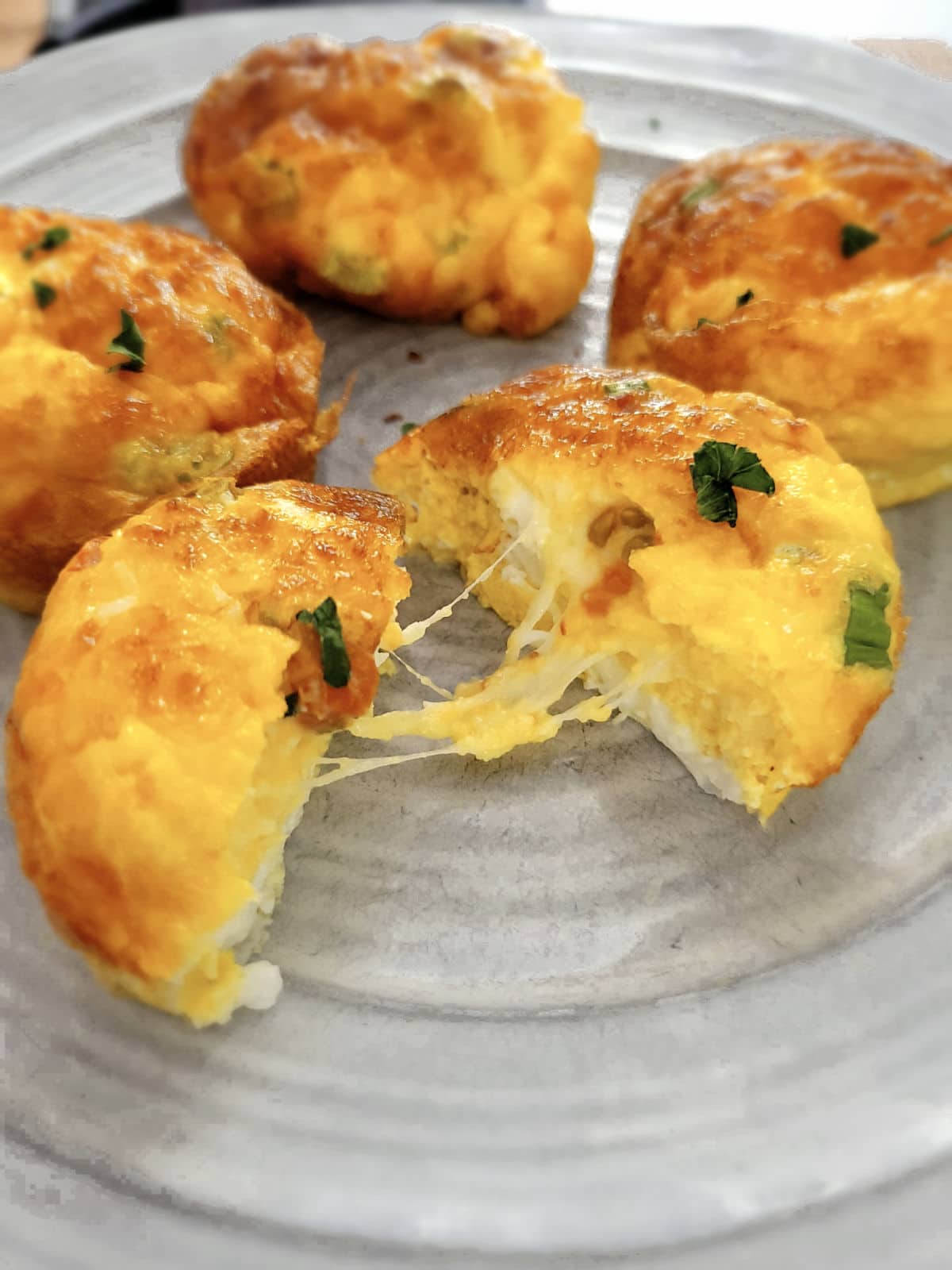 cheesy and fluffy egg bites, sliced open in the middle