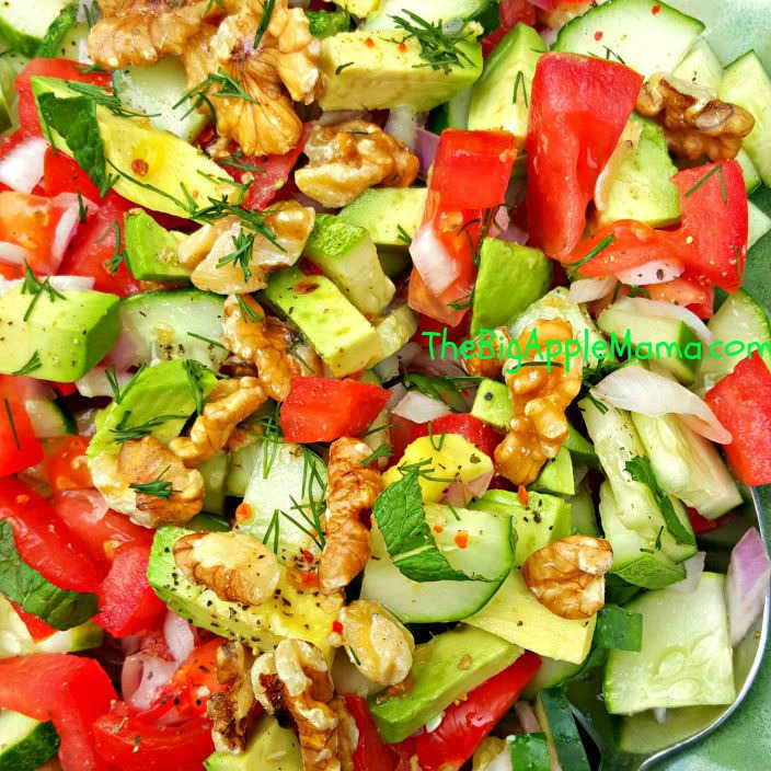 beautiful summer salad with tomatoes, cucumber, avocado and nuts