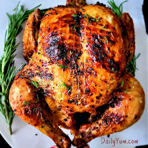whole chicken with golden skin and grill marks from air fryer basket