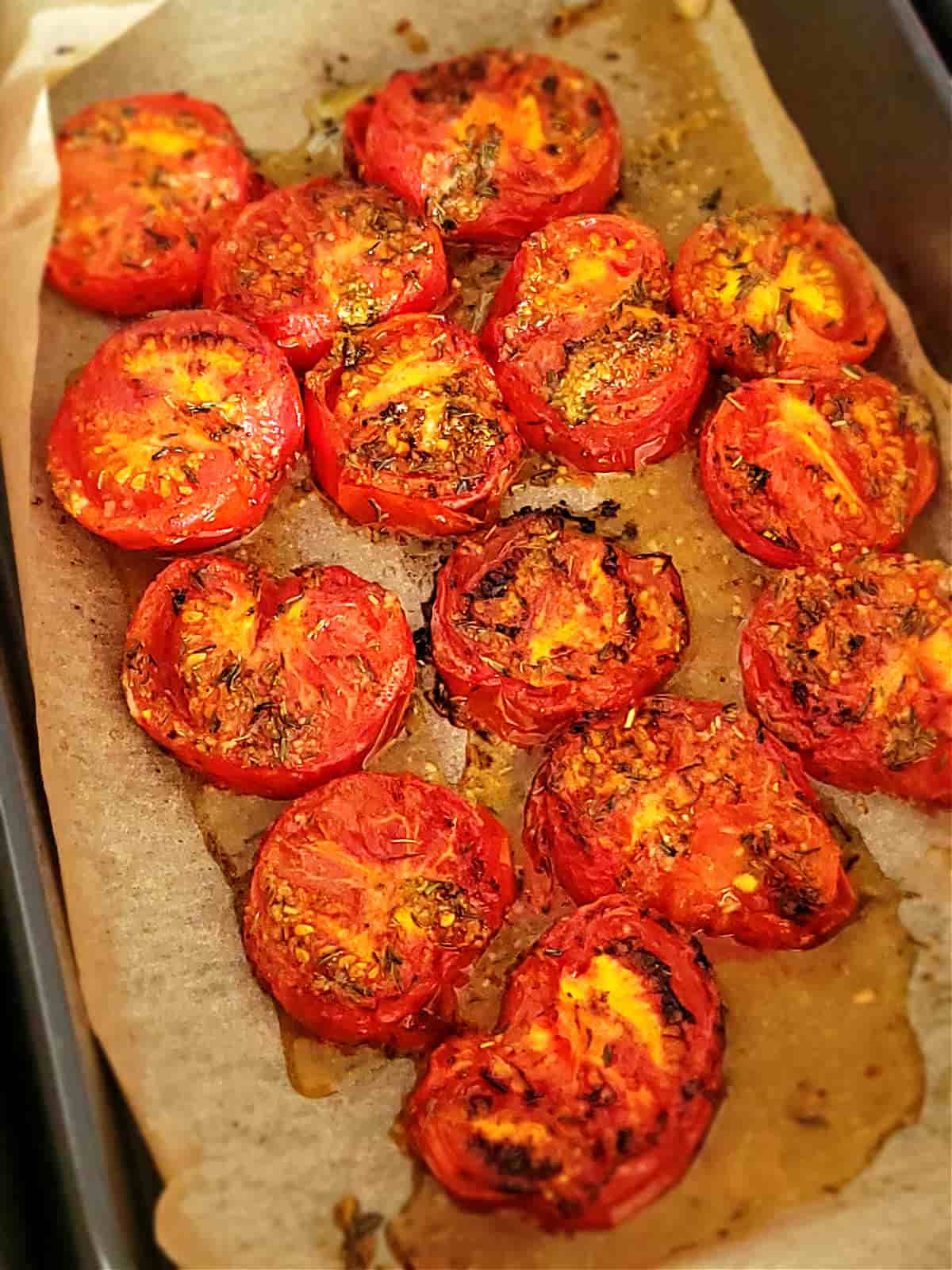 roasted tomatoes laid on parchment paper