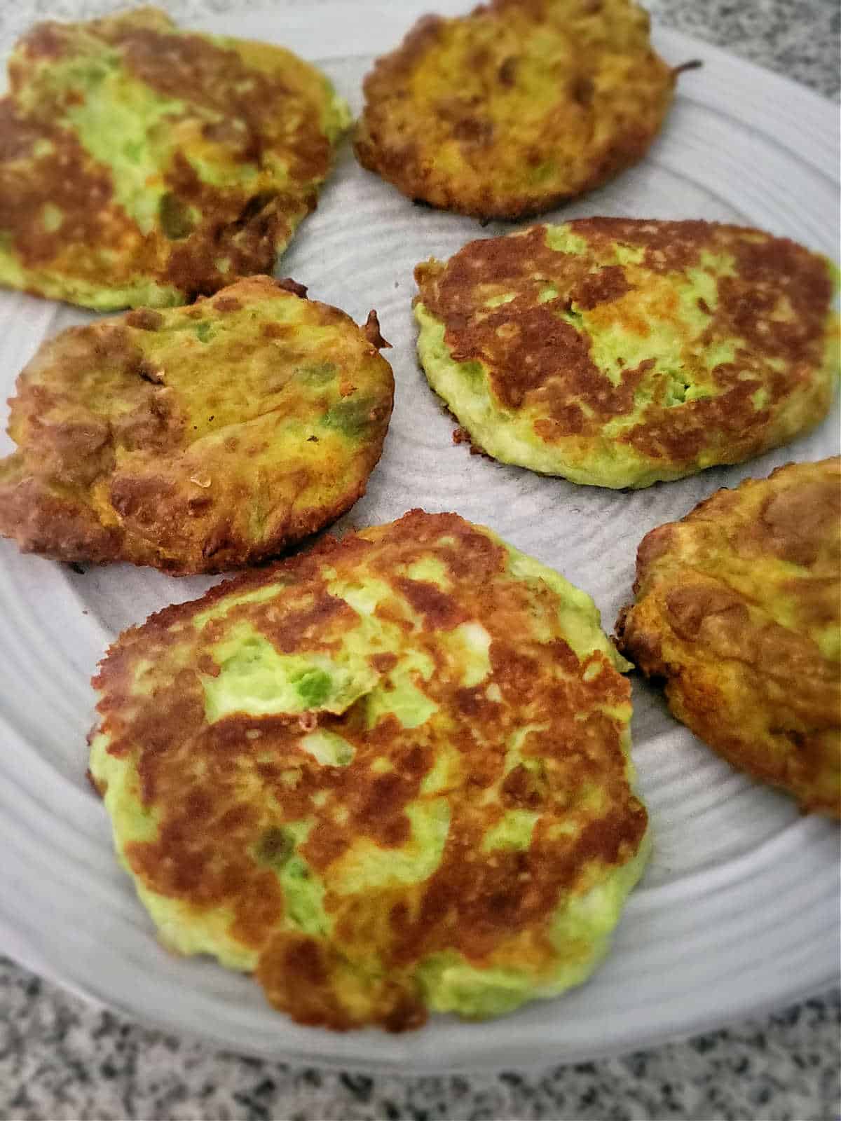 golden charred cakes on a plate