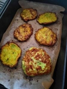 golden fritters on parchment paper in air fryer