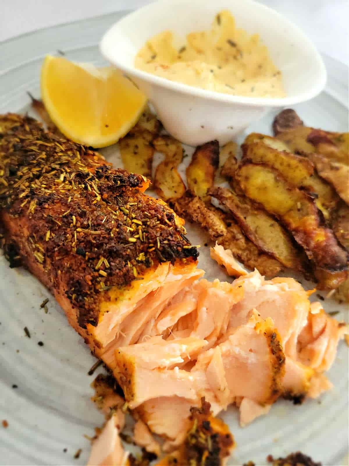 flaky salmon with potato peels and creamy sauce