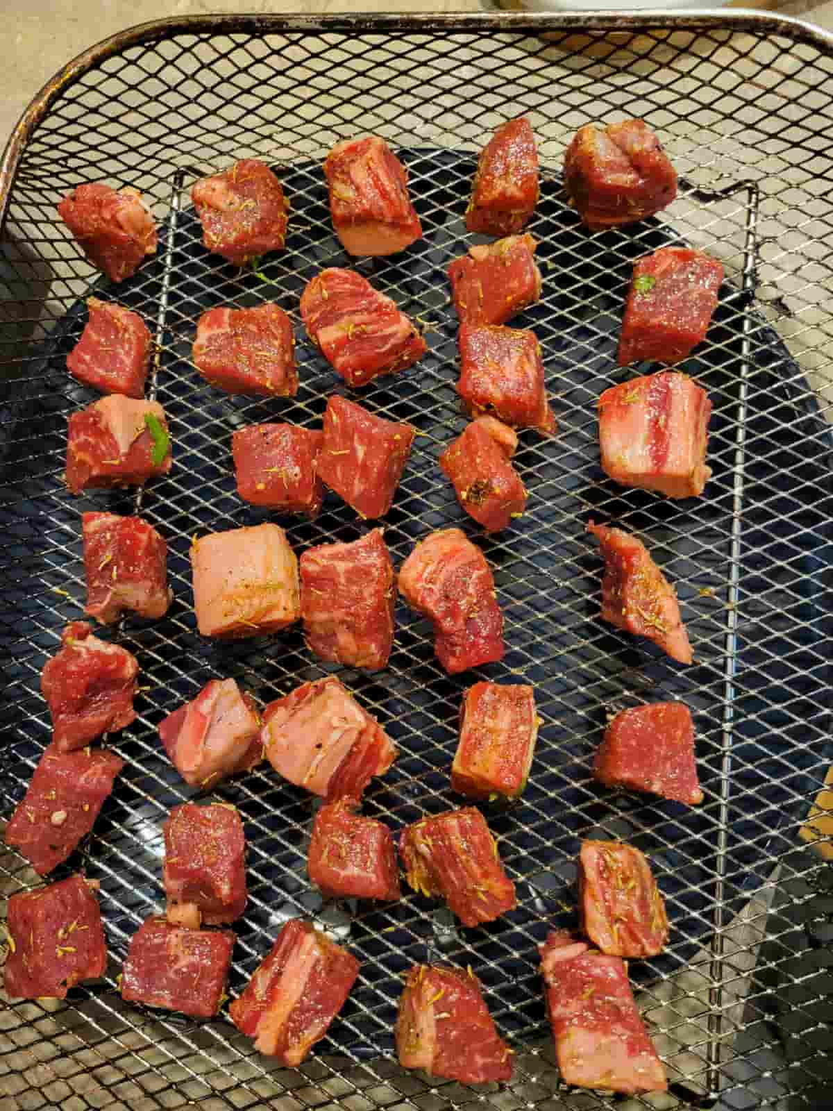 steak cubes in air fryer mesh tray