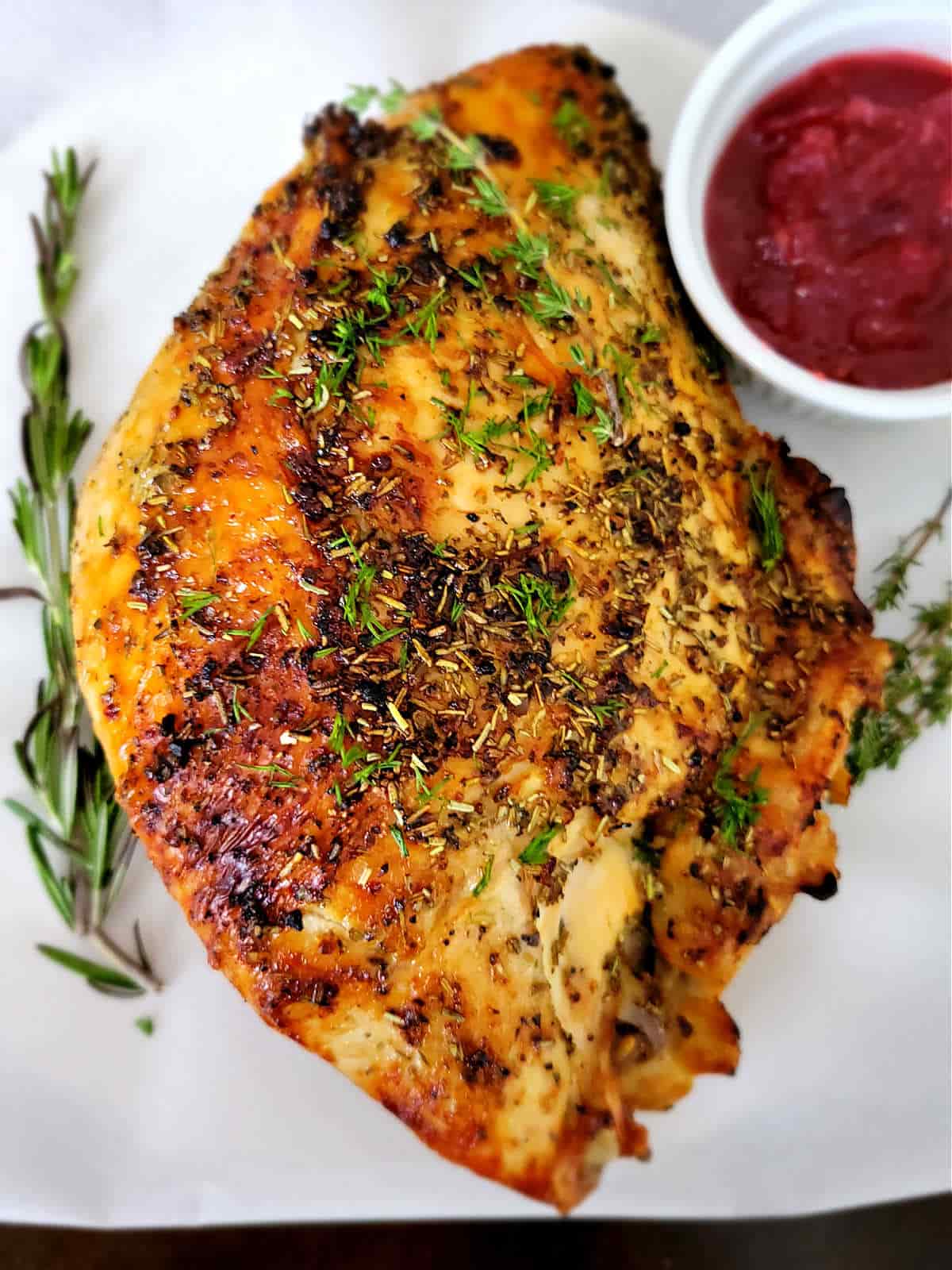 whole turkey breast, golden brown with crispy herbs on top