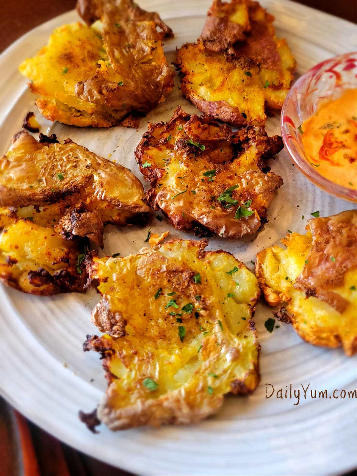 beautiful and golden smashed potatoes on the plate