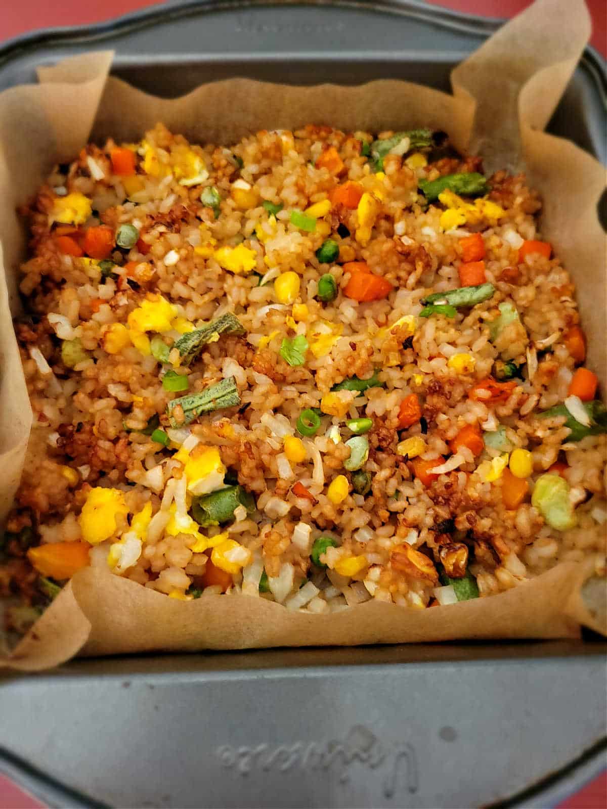 fried rice in a baking dish lined with parchment paper