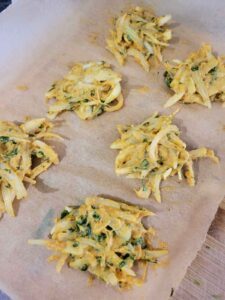 onion fritters on parchment paper