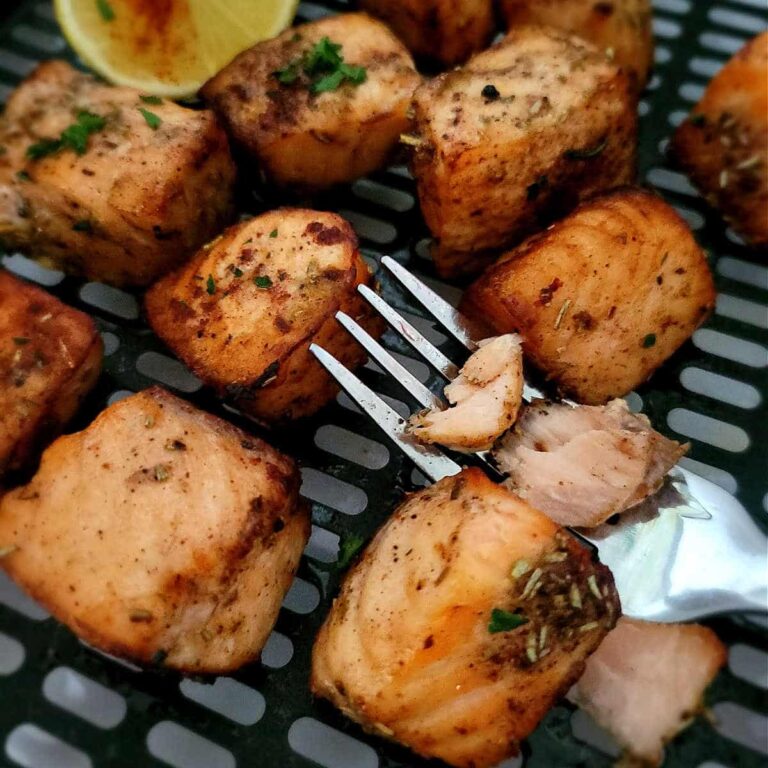charred salmon bites in air fryer basket