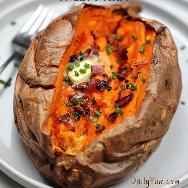 Golden-brown air-fried baked sweet potato with crispy skin and a soft, fluffy inside, served on a plate with butter melting on top