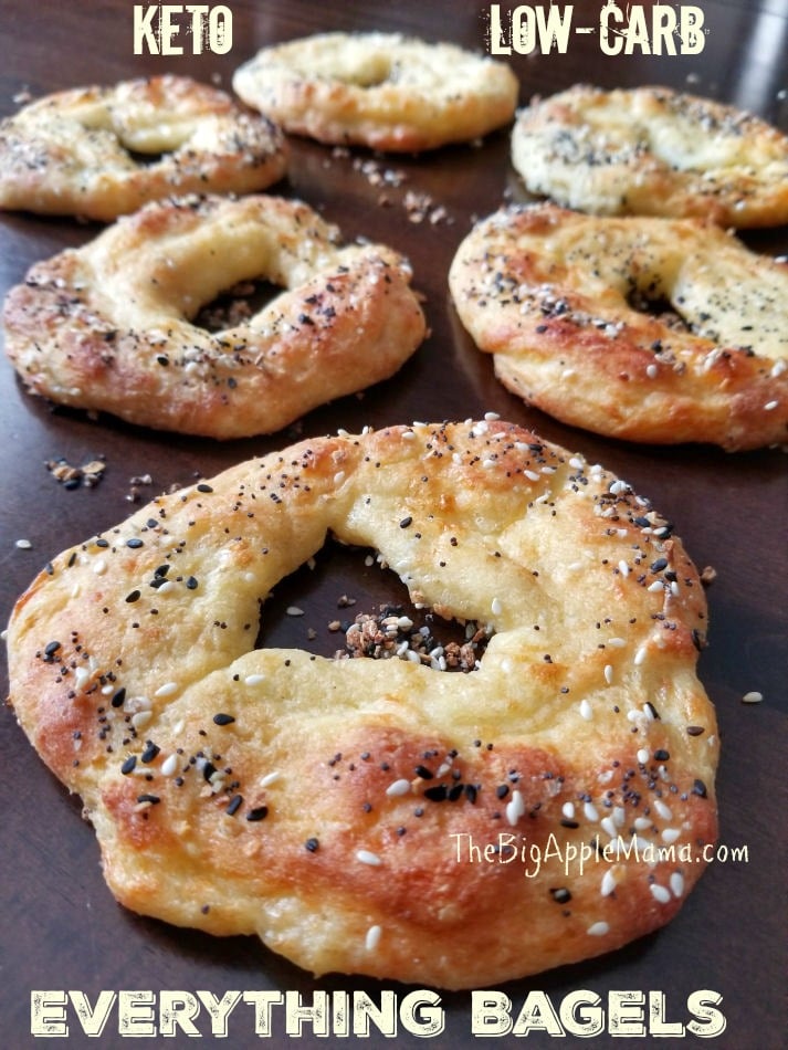 Freshly baked low carb bagels on a cooling rack, slightly flat in shape but golden and chewy, topped with "Everything but the Bagel" seasoning.