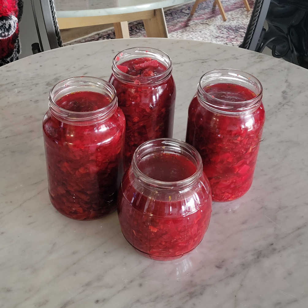 Storing borscht in glass jars or plastic containers for freshness and easy reheating.